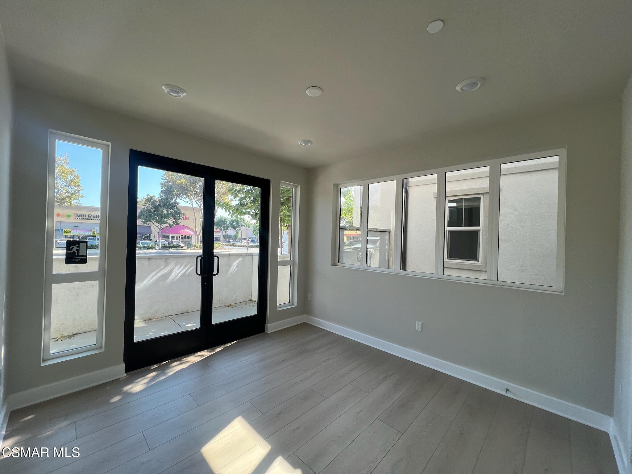 3005 Cochran Street Simi Valley, CA 93065 - Photo 9 of 57 an empty room with wooden floor and windows