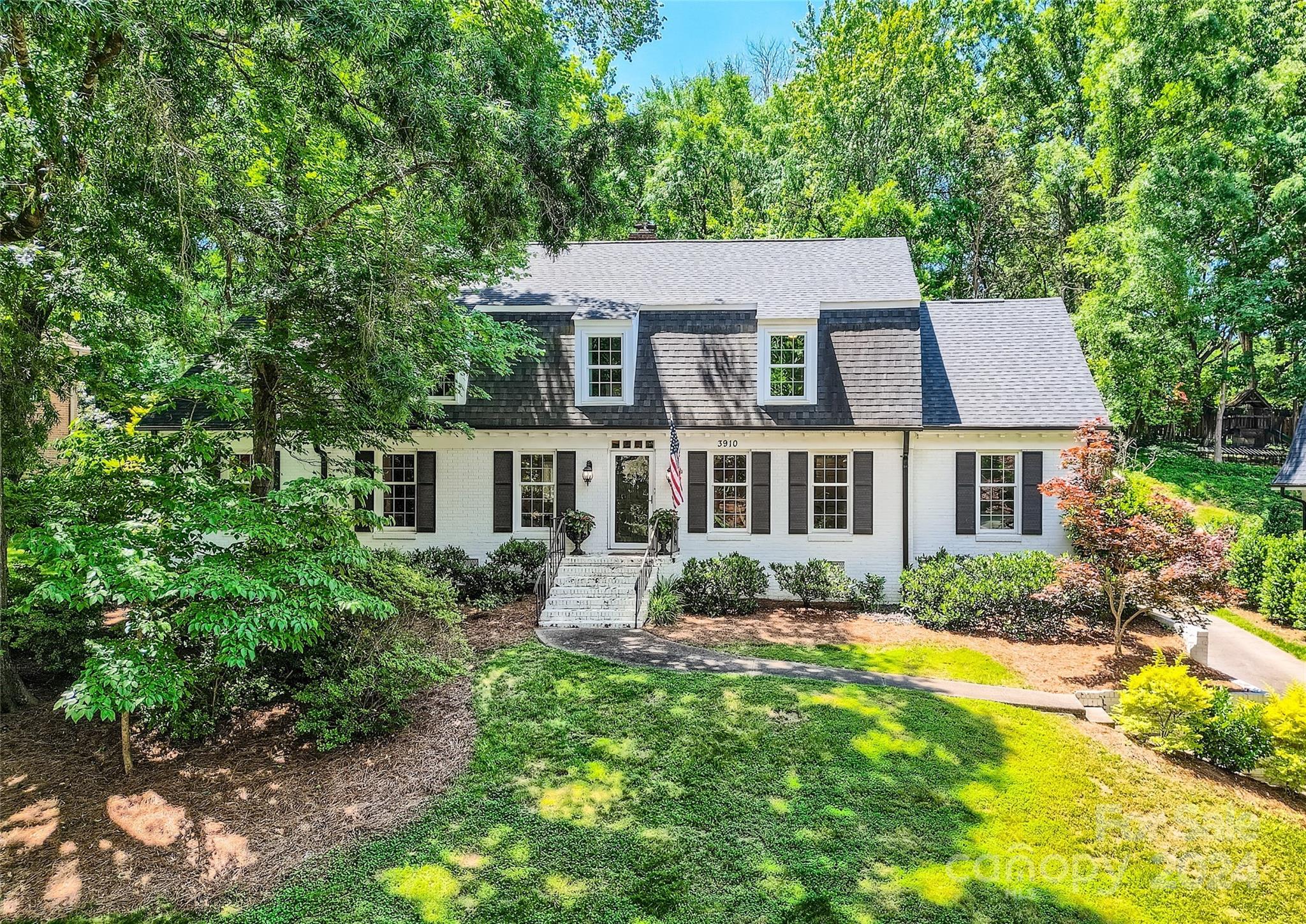 3910 Chevington Road Charlotte, NC 28226 - Photo 1 of 40 a front view of a house with yard and green space