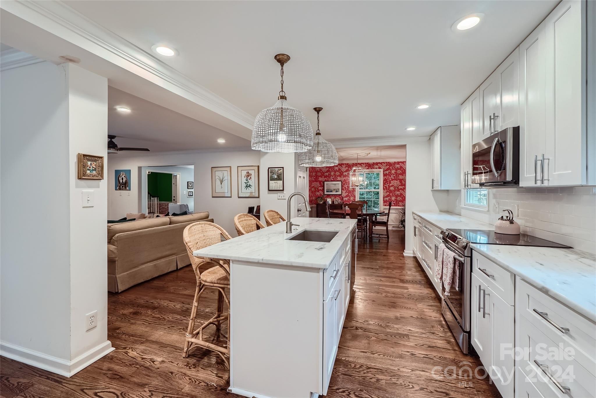 3910 Chevington Road Charlotte, NC 28226 - Photo 12 of 40 a large kitchen with stainless steel appliances kitchen island granite countertop a sink counter space and a view of living room