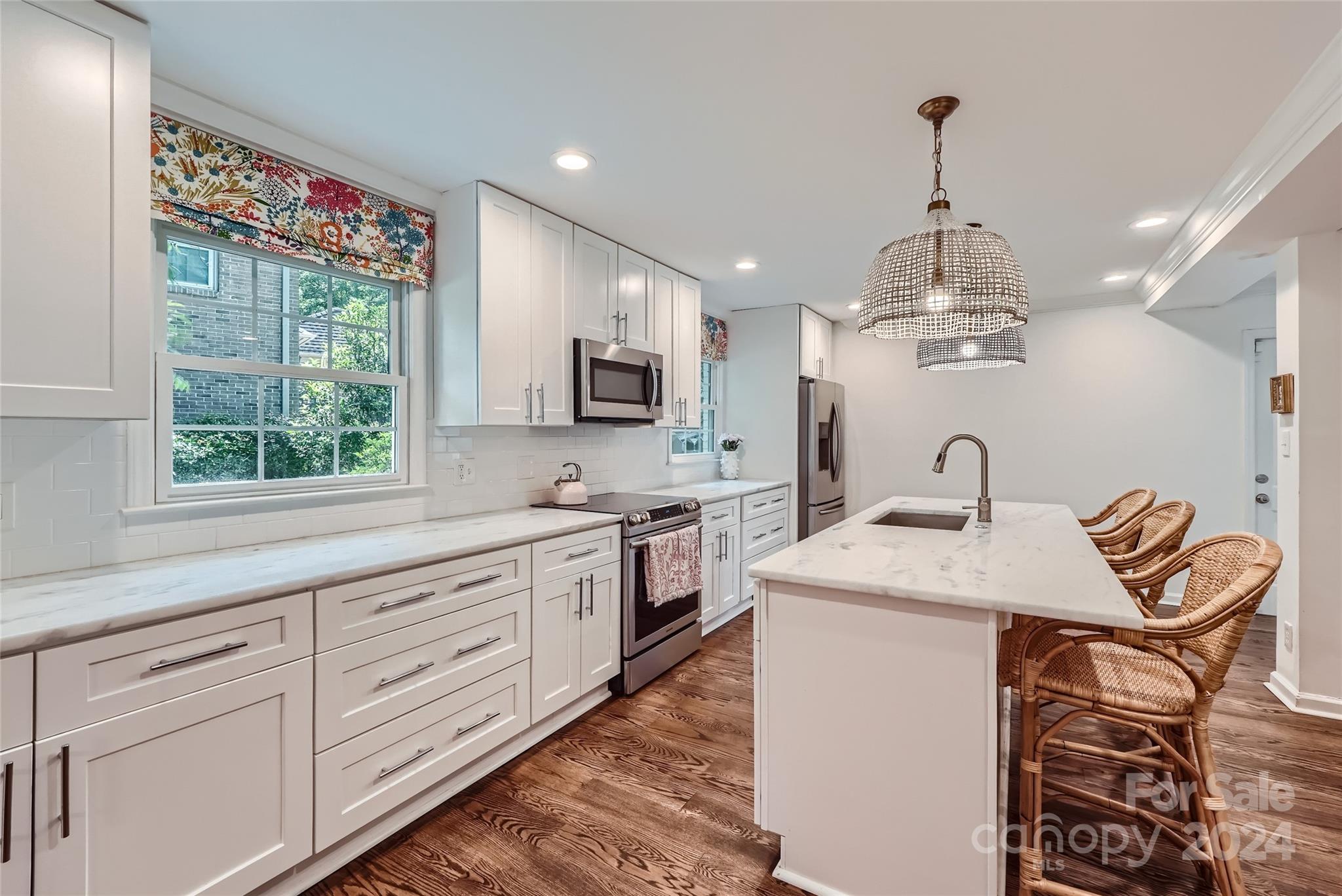 3910 Chevington Road Charlotte, NC 28226 - Photo 14 of 40 a kitchen with kitchen island granite countertop a sink a counter space appliances and cabinets
