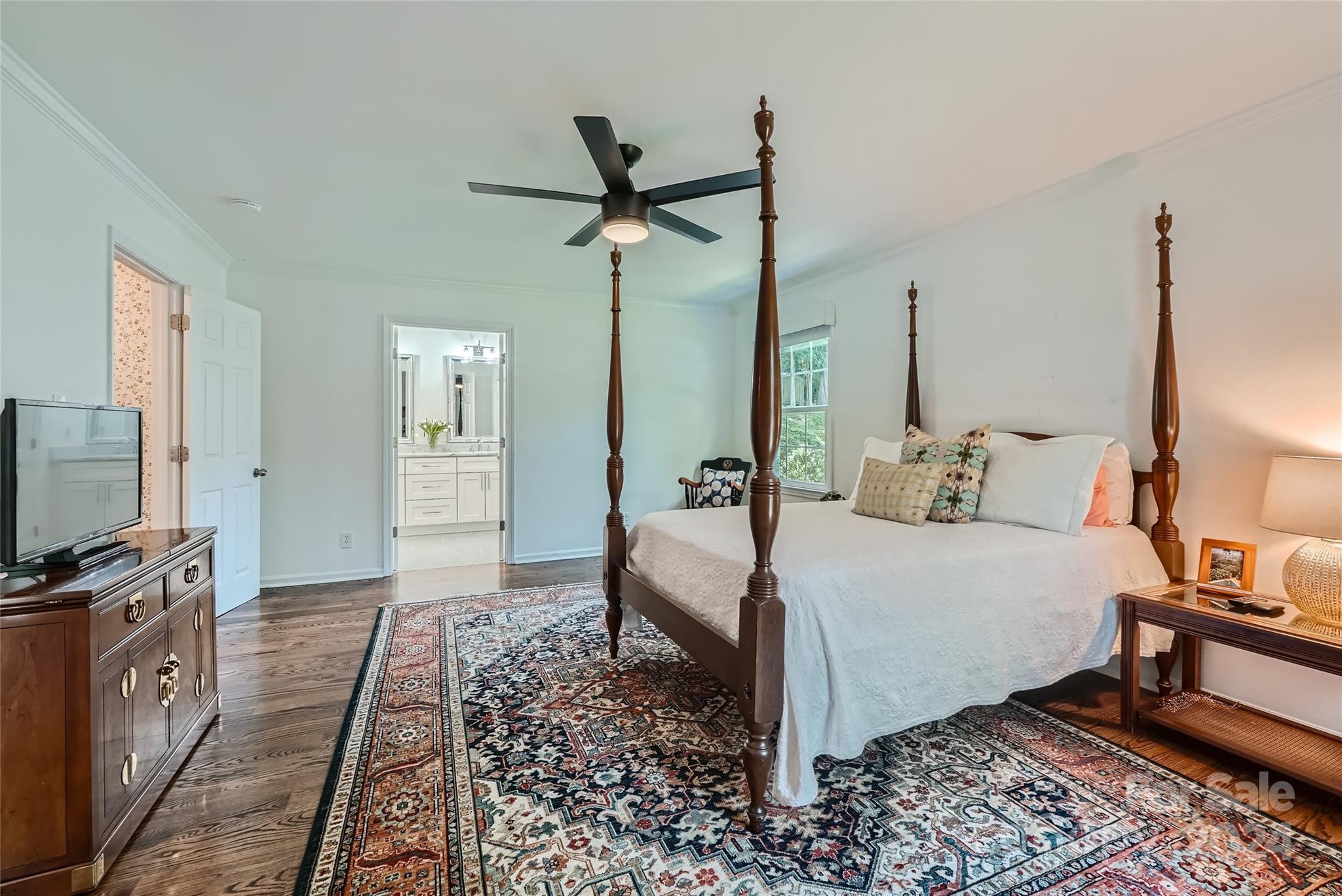 3910 Chevington Road Charlotte, NC 28226 - Photo 24 of 40 a room with a bed a flat screen tv and a dresser