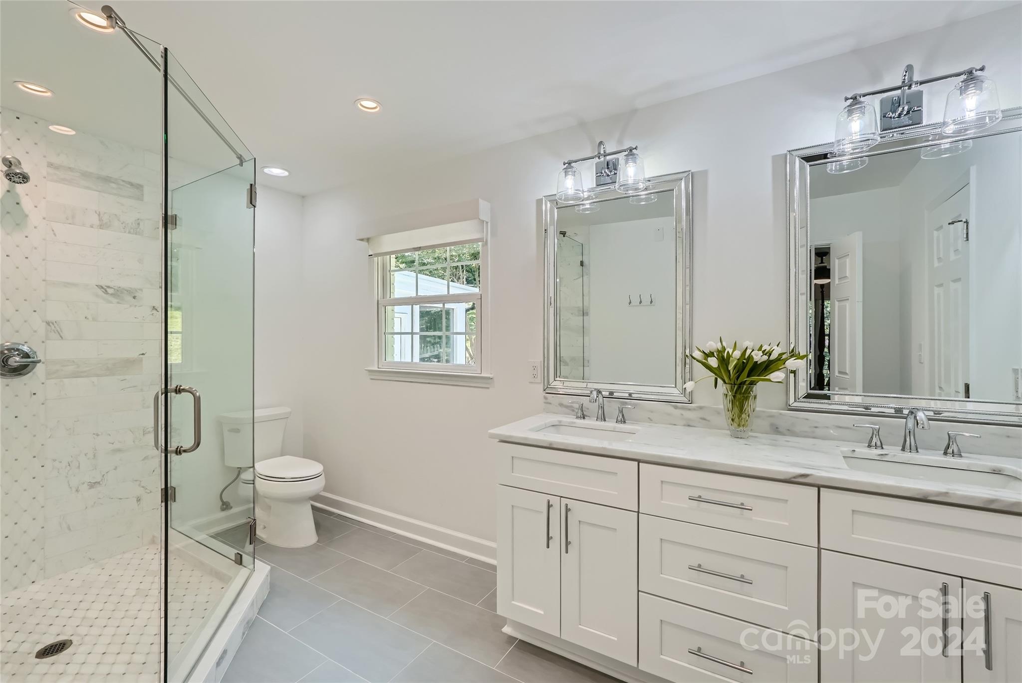 3910 Chevington Road Charlotte, NC 28226 - Photo 25 of 40 a bathroom with a double vanity sink toilet and shower