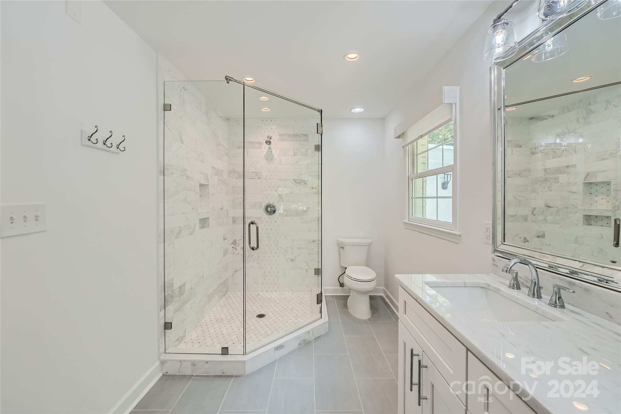 3910 Chevington Road Charlotte, NC 28226 - Photo 26 of 40 a bathroom with a granite countertop sink a toilet and shower
