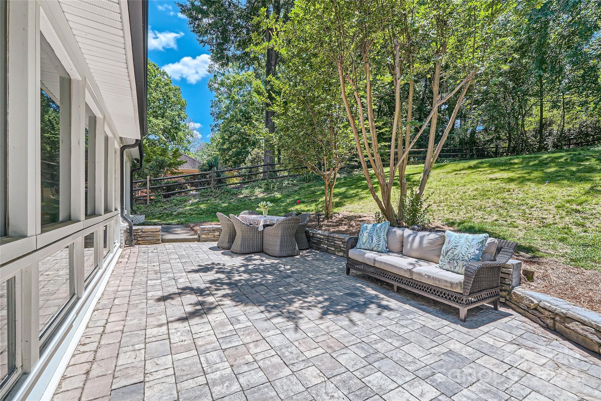 3910 Chevington Road Charlotte, NC 28226 - Photo 36 of 40 a view of a patio with couple of chairs and a fire pit