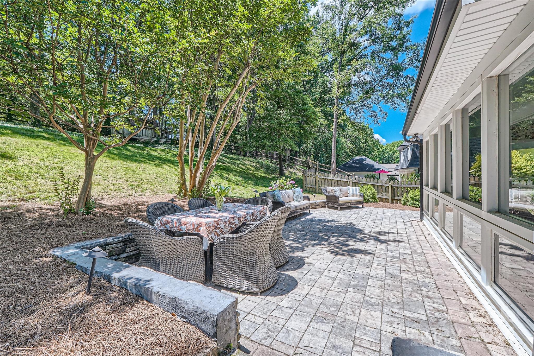 3910 Chevington Road Charlotte, NC 28226 - Photo 37 of 40 a view of a patio with table and chairs and potted plants