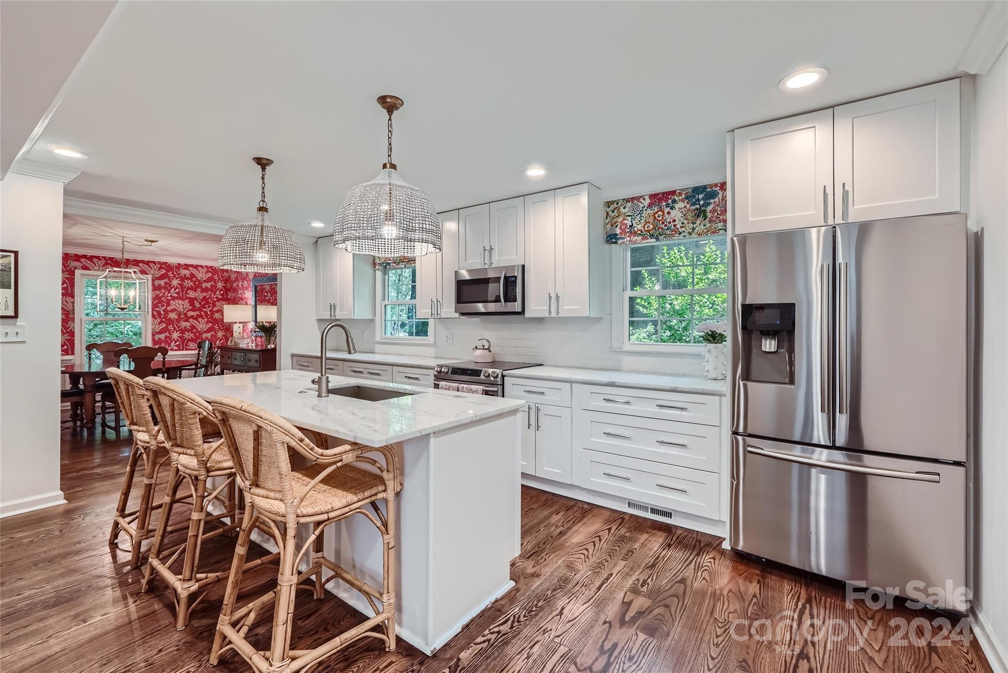 3910 Chevington Road Charlotte, NC 28226 - Photo 9 of 40 a kitchen with kitchen island wooden floors and stainless steel appliances