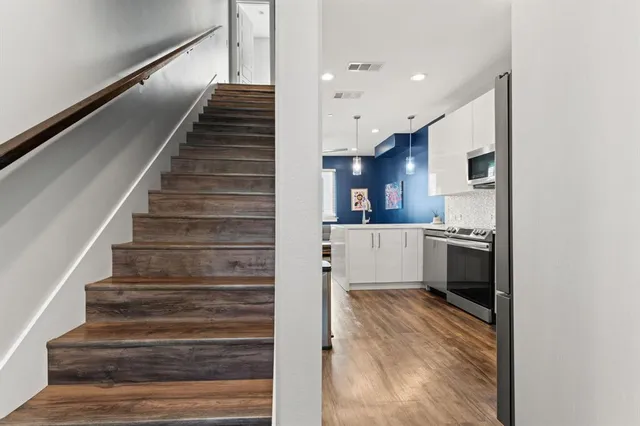 a view of kitchen with wooden floor and electronic appliances
