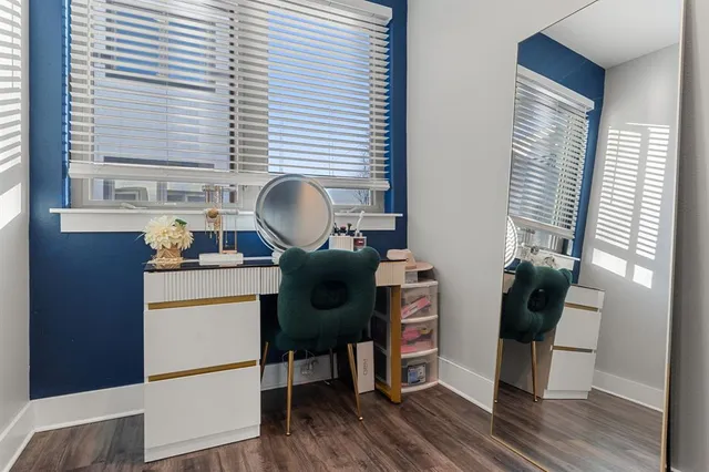 a view of a workspace with furniture and a window