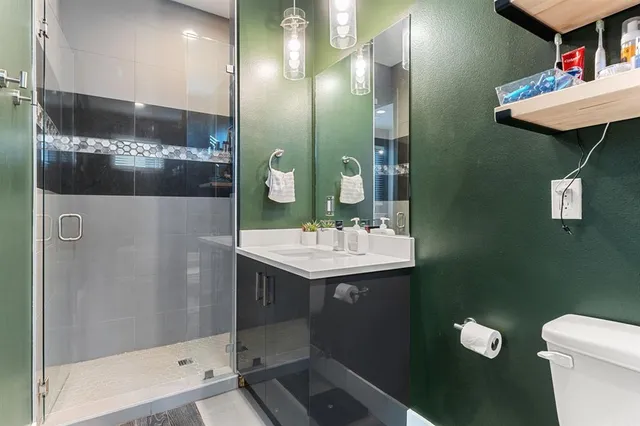 a bathroom with a sink toilet and shower