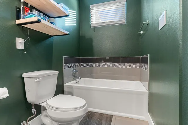 a white toilet sitting next to a bathroom sink