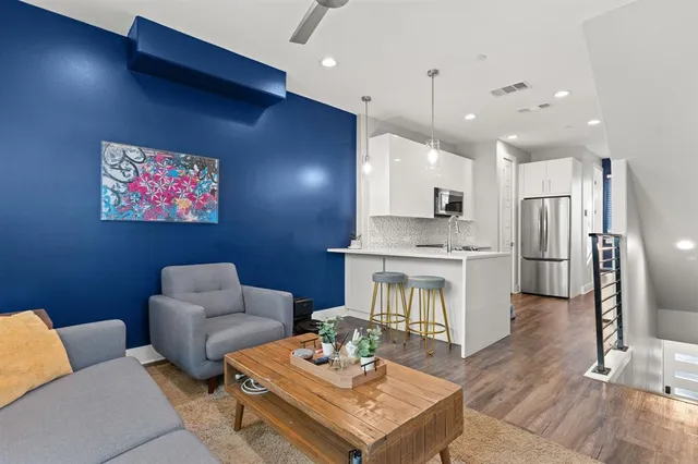 a living room with furniture and a kitchen view