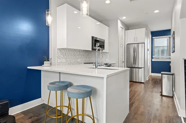 a kitchen with stainless steel appliances a sink and a refrigerator