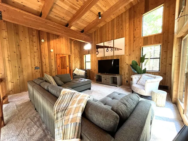 a living room with furniture a fireplace and a flat screen tv