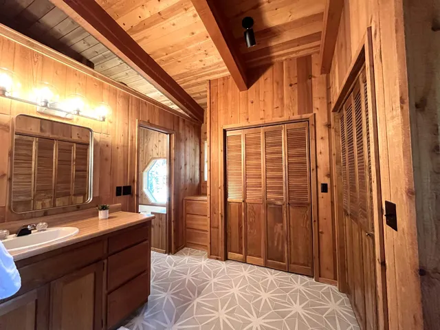 a bathroom with a double vanity sink and a mirror