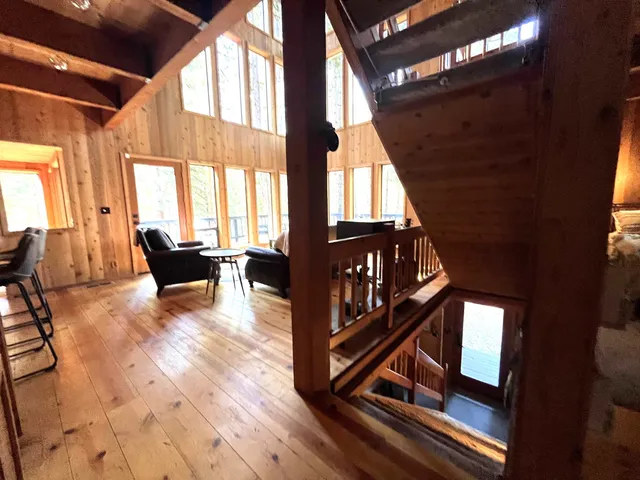 a view of an entryway with wooden floor and door