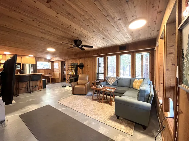 a living room with furniture and a chandelier