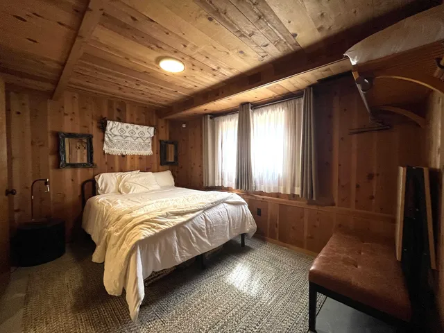 a bed sitting in a bedroom next to a window