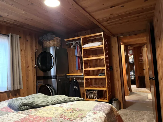 a bedroom with a bed and walk in closet