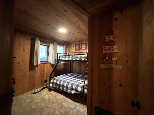 a bedroom with a bed and large window