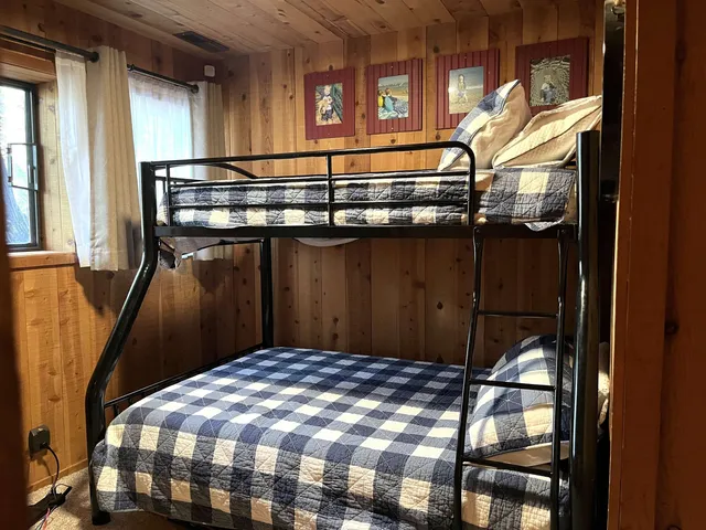 a view of a patio with couches table and chairs and wooden floor