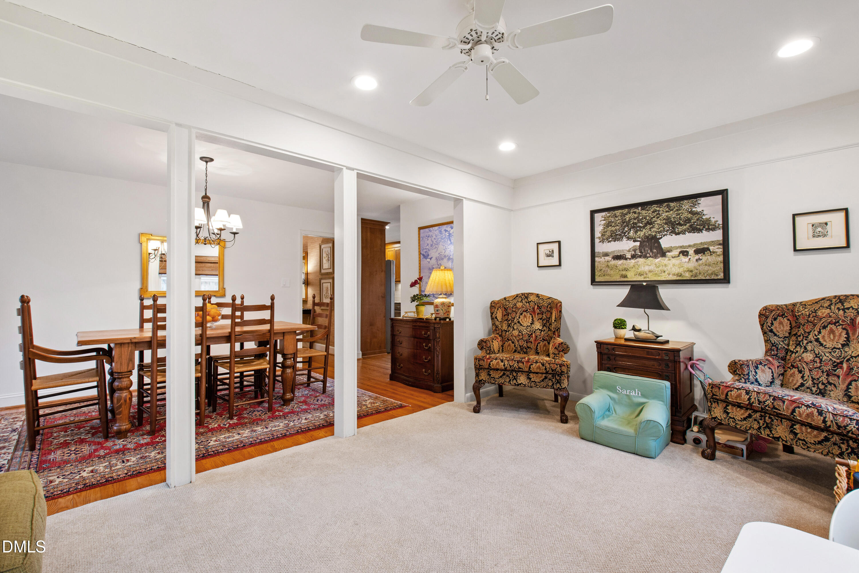 908 Brookwood Drive Raleigh, NC 27607 - Photo 14 of 27 a living room with furniture and a chandelier
