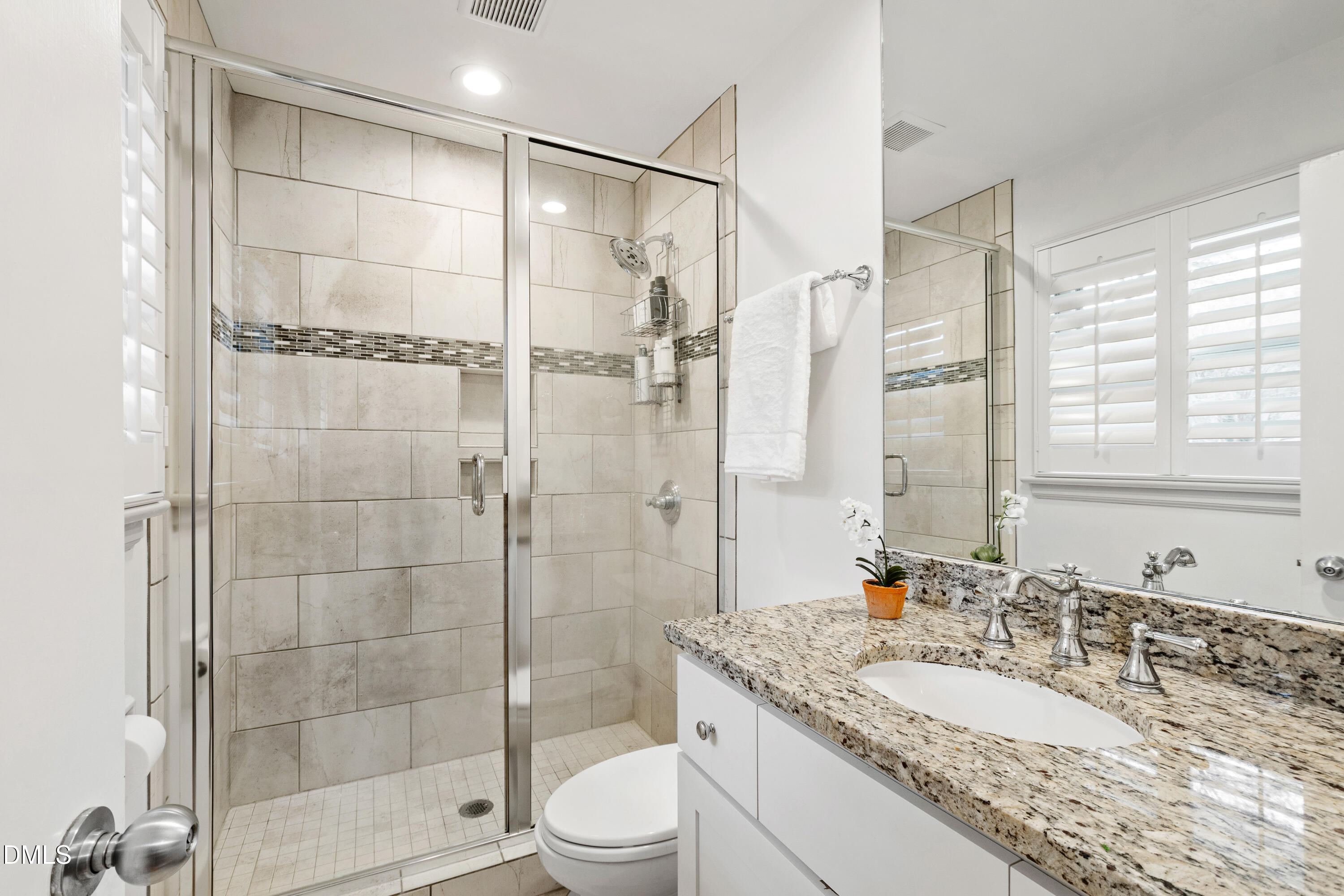 908 Brookwood Drive Raleigh, NC 27607 - Photo 16 of 27 a bathroom with a granite countertop sink a toilet and shower