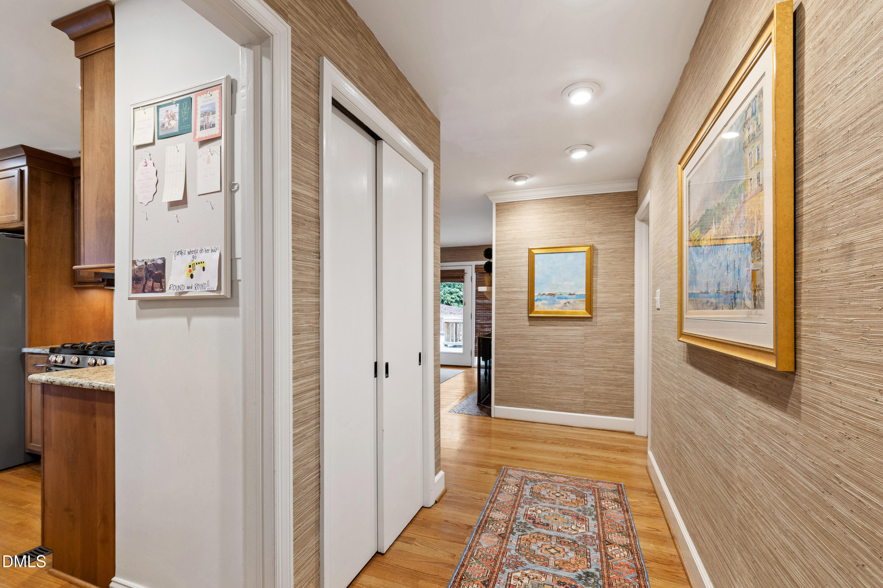 908 Brookwood Drive Raleigh, NC 27607 - Photo 4 of 27 a view of a hallway with a livingroom and a dinning room with furniture