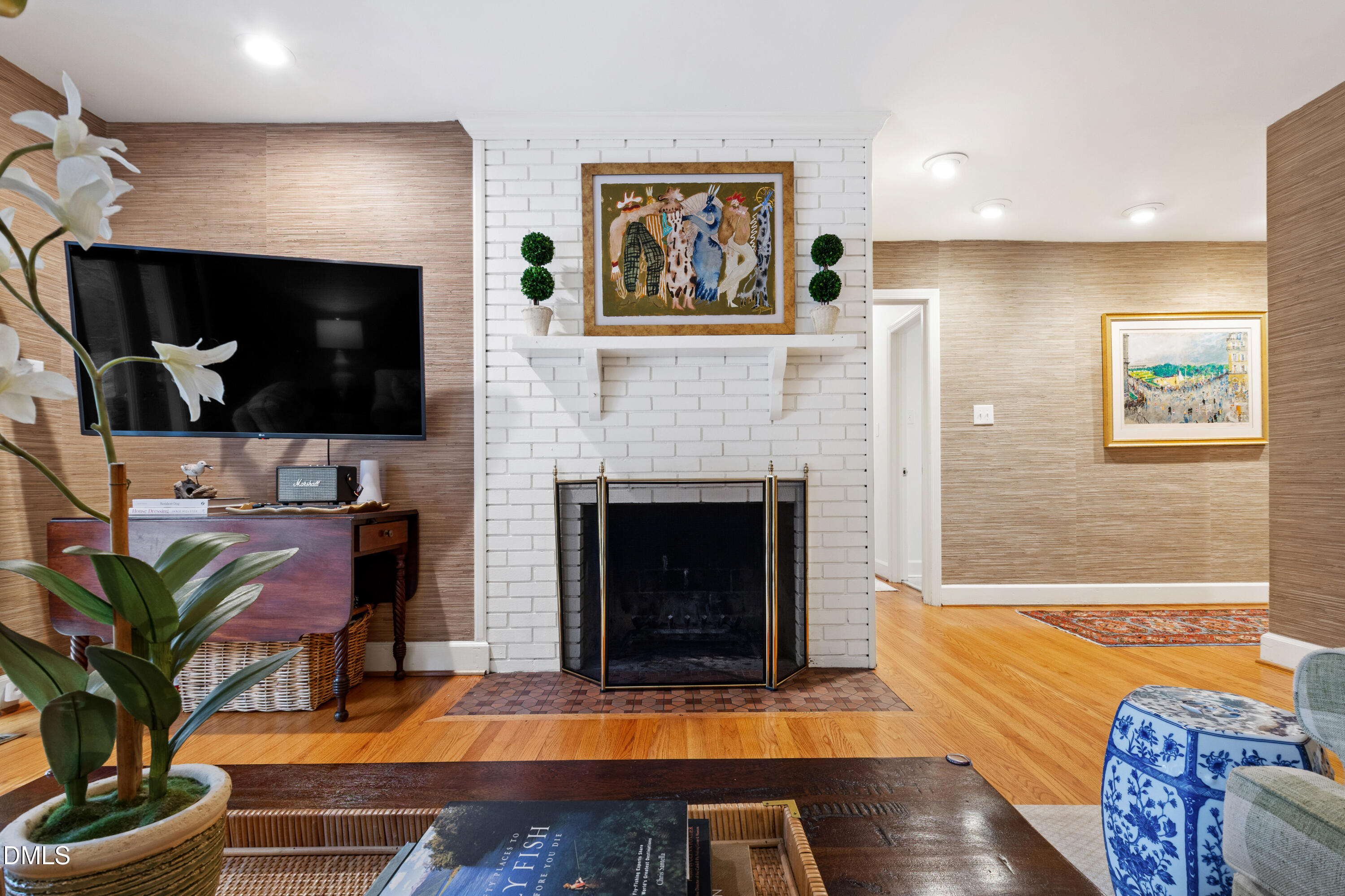 908 Brookwood Drive Raleigh, NC 27607 - Photo 7 of 27 a living room with furniture fireplace and flat screen tv