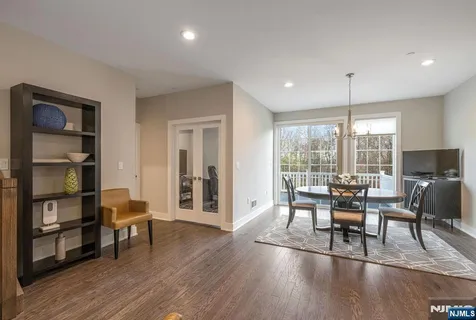 a dining room with furniture and wooden floor
