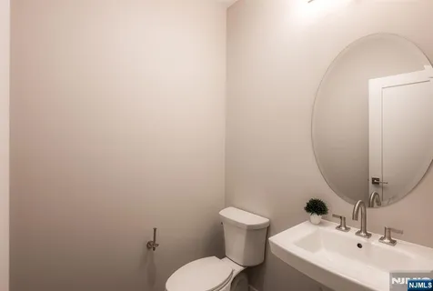 a bathroom with a sink mirror and toilet