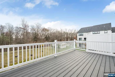 a view of balcony with wooden floor and fence