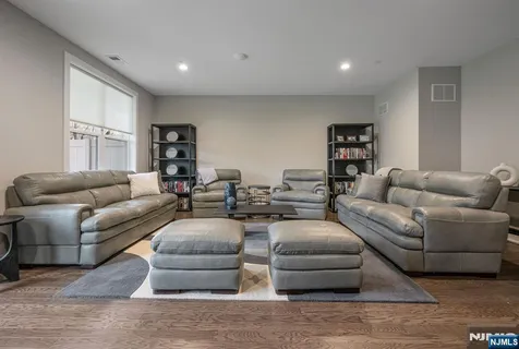 a living room with furniture and hard wood flooring