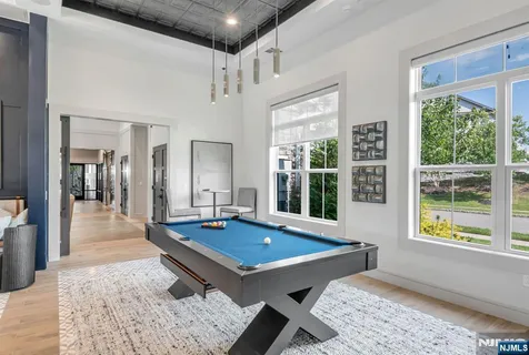 a living room with pool table and a table