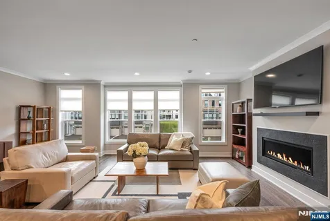 a living room with furniture large window and a fireplace