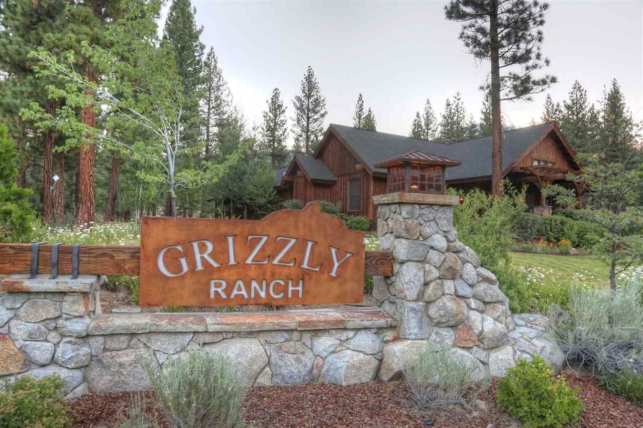 486 Grizzly Ranch Road Portola, CA 96122 - Photo 8 of 8 a sign that is sitting in front of a brick house with large trees