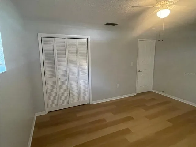 an empty room with closet area
