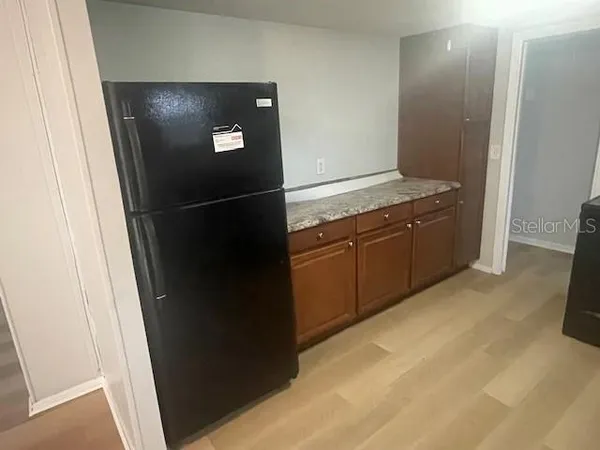 a kitchen with stainless steel appliances granite countertop and refrigerator