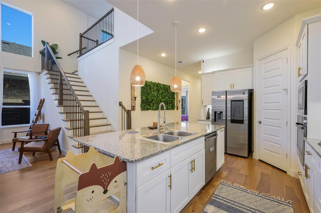 3603 Scotsman Road Sachse, TX 75048 - Photo 8 of 33 a kitchen with granite countertop a sink appliances and cabinets