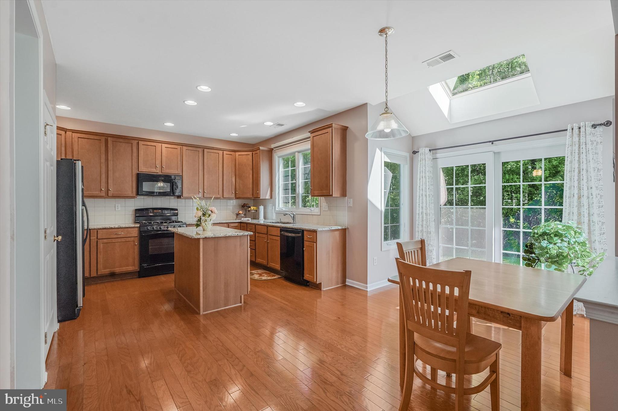 14 Devonshire Drive Princeton, NJ 08540 - Photo 11 of 36 a kitchen with a table chairs refrigerator and microwave