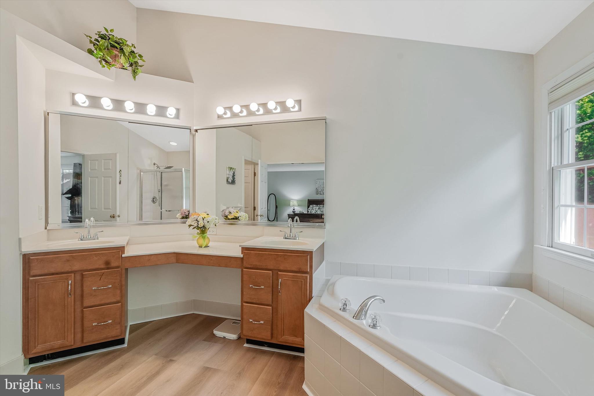 14 Devonshire Drive Princeton, NJ 08540 - Photo 22 of 36 a bathroom with a tub a sink double vanity and a window
