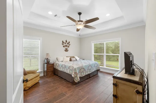 a living room with a bed furniture and a large window