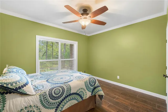 a bed sitting in a bedroom next to a window