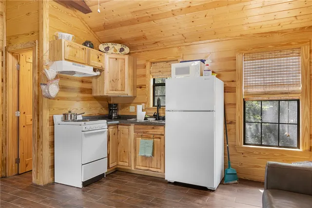 a kitchen with stainless steel appliances a refrigerator and a stove