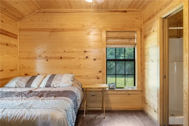 a bed sitting in a bedroom next to a window