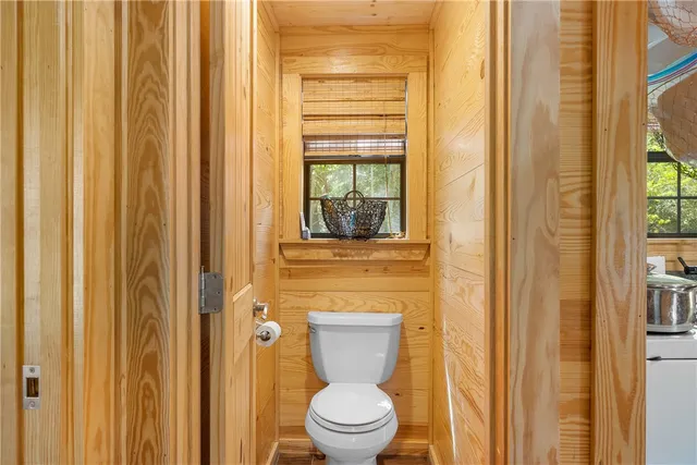 a bathroom with a toilet and a shower curtain