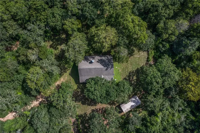 an aerial view of a house with yard and outdoor seating