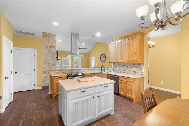 a kitchen with a sink cabinets and wooden floor