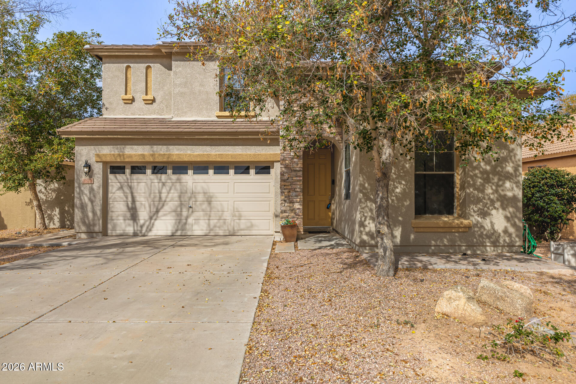 a front view of a house with a yard and garage