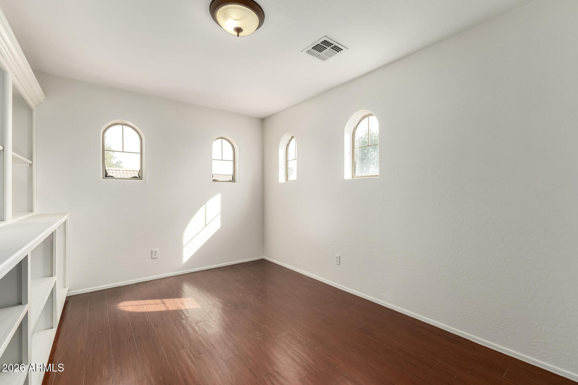 3628 East Janelle Way Gilbert, AZ 85298 - Photo 15 of 38 a view of an empty room with wooden floor and a window