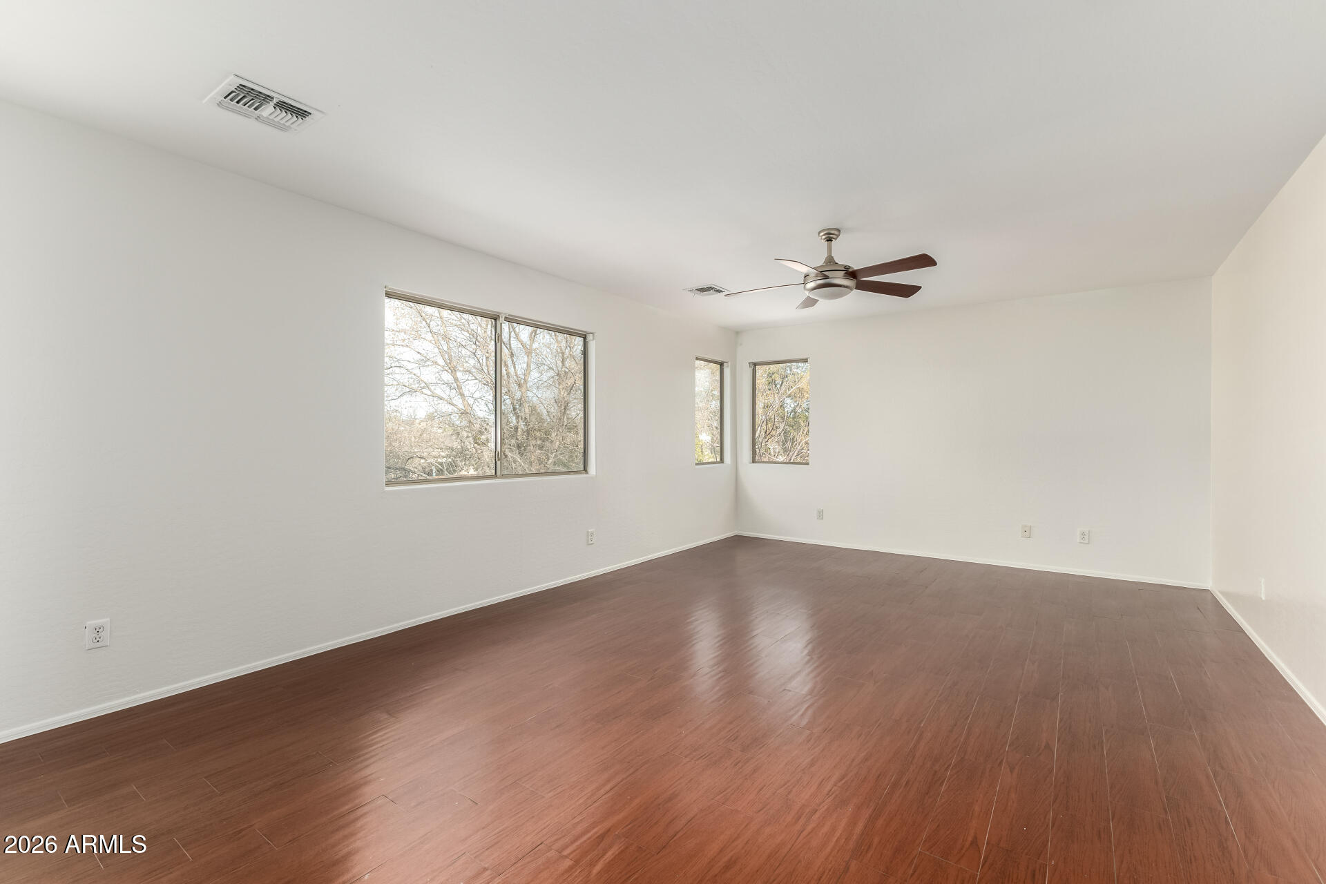 3628 East Janelle Way Gilbert, AZ 85298 - Photo 17 of 38 wooden floor in an empty room with a window